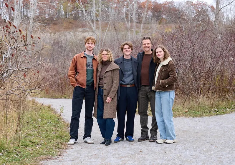 James Dann with family outdoors.